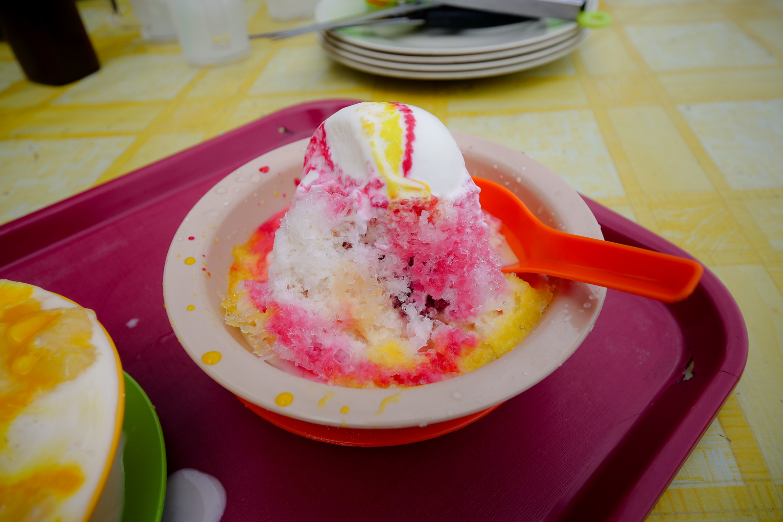 Ice cream and shaved ice, covered with sweet and colorful syrup
