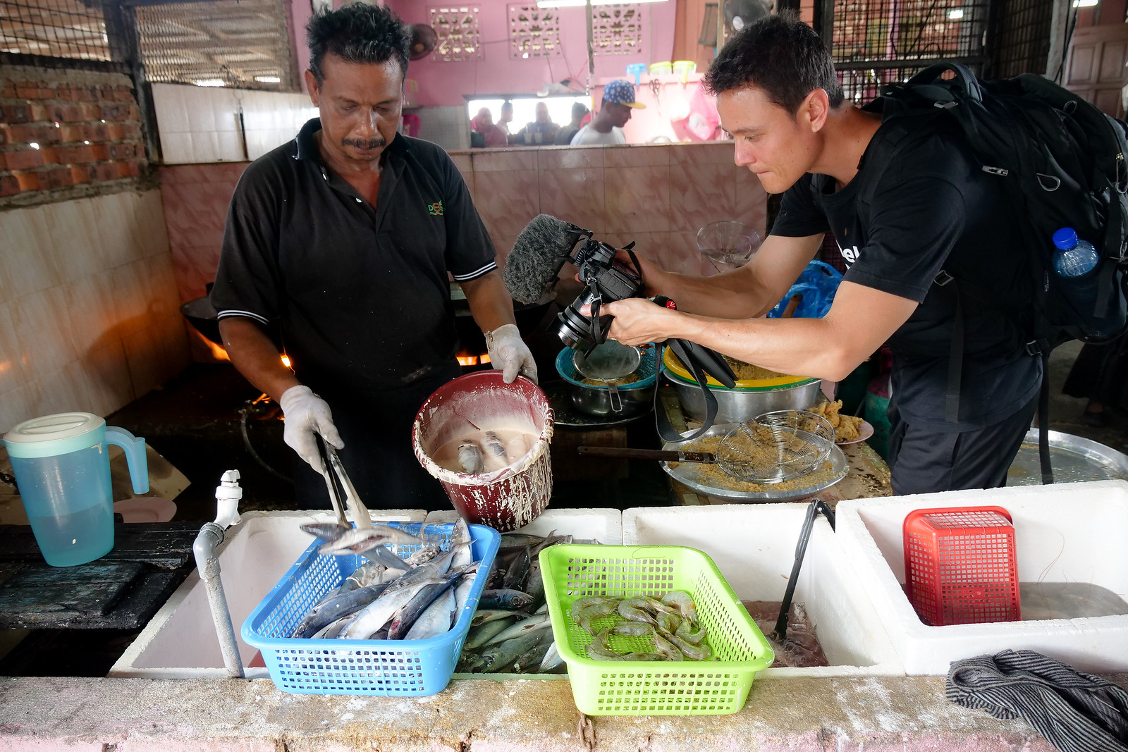 The chef here is working with hundreds of fish per hour, deep frying every last one