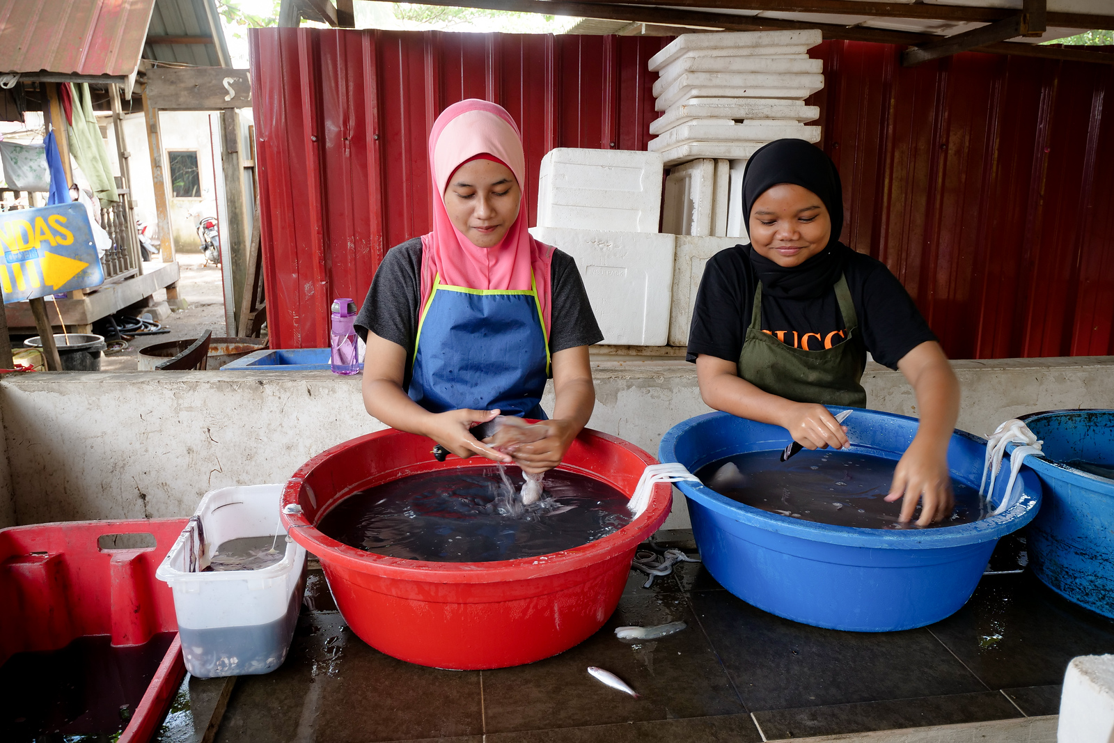 These two girls are experts at quickly cleaning each squid before the deep frying which comes next