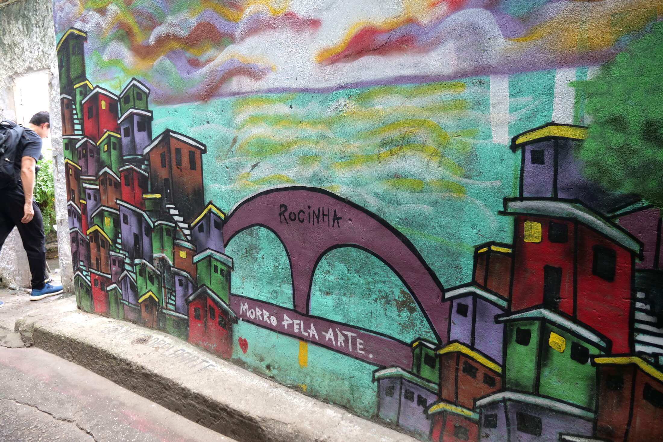 See the following photos for views of the Gate of Heaven. This photo shows some artwork depicting the entrance to the Rocinha favela itself, visible in the distance far below